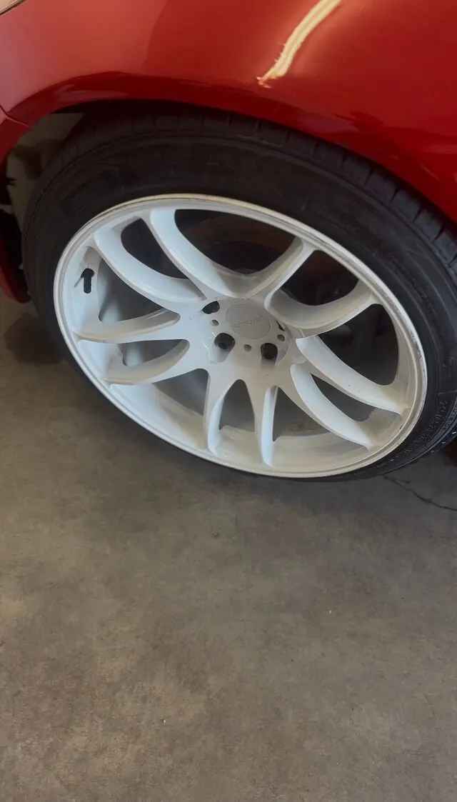 Clean white wheel and dressed tire